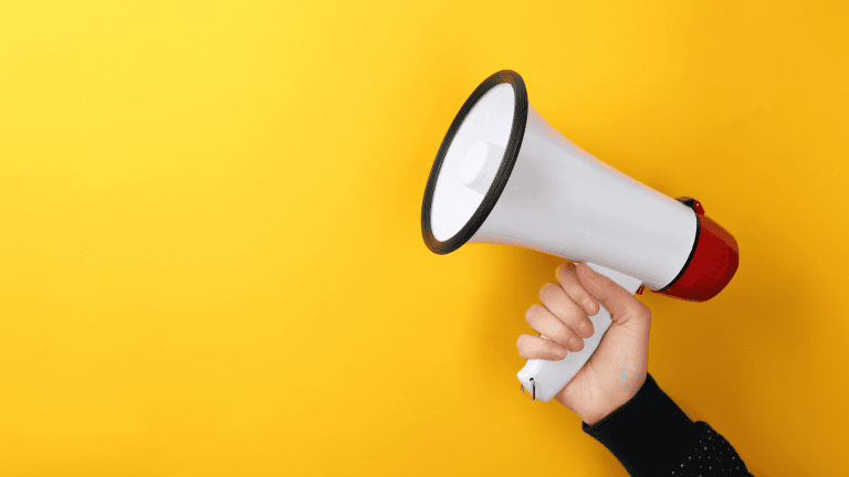 A hand holding a megaphone