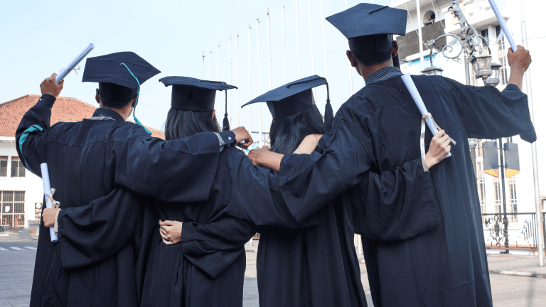 a group of people in graduation gowns are standing on the street
