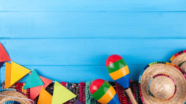 colorful hats and maracas on a blue wooden background