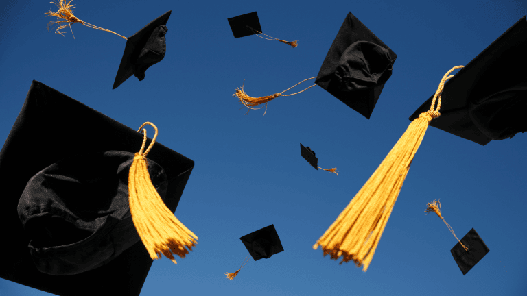 A group of graduation caps flying in the air