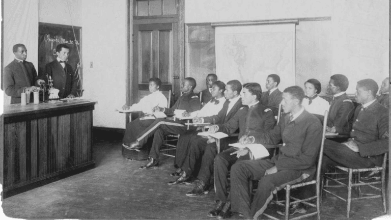 Two instructors presenting to a class of students in a classroom.