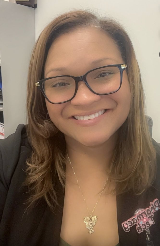 A smiling woman wearing glasses