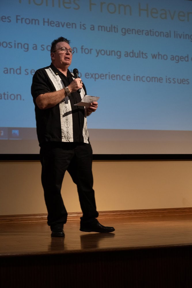 A man standing on a stage speaking