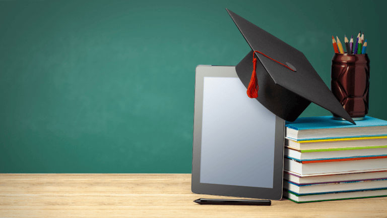 a graduation cap is sitting on top of a stack of books