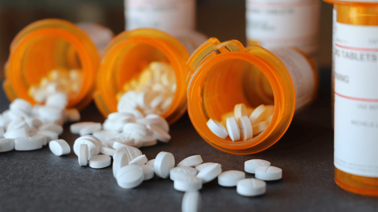 pills and prescription bottles sit on a table