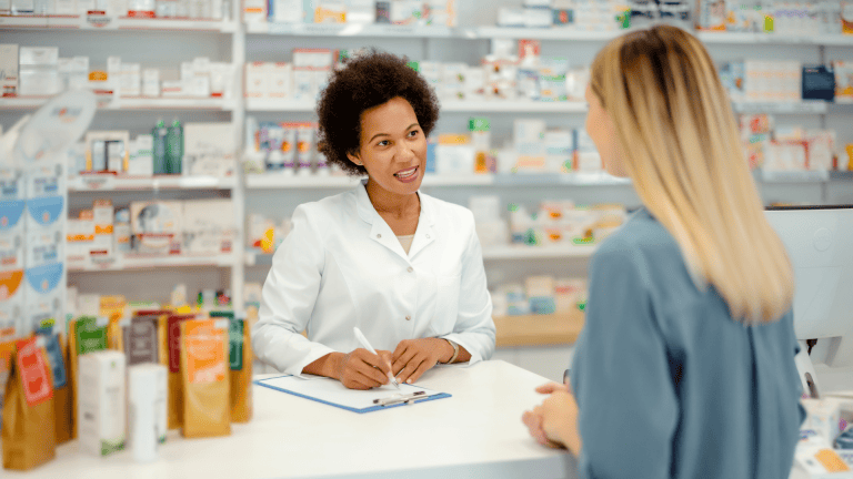 Two people are talking in a pharmacy shop