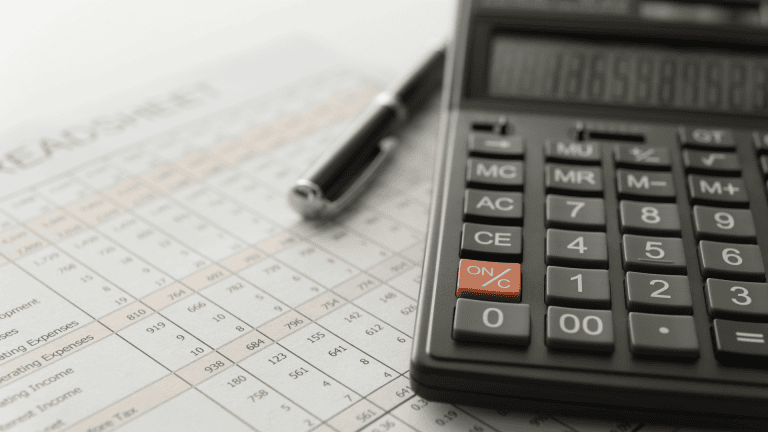 a calculator and pen on a financial statement